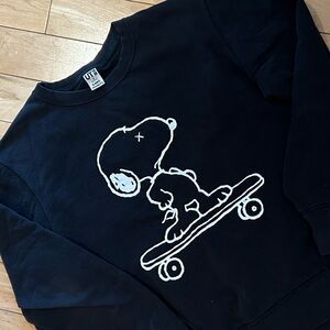 Uniqlo x KAWS Black Crewneck Sweatshirt with White Snoopy Skateboard Graphic
